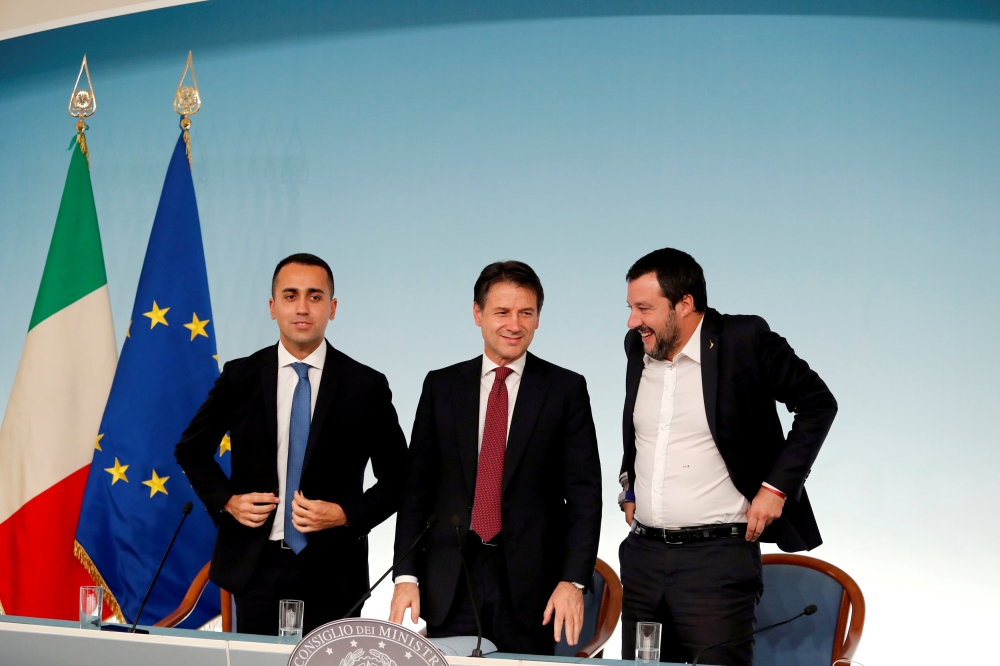 :FILE PHOTO: Italy's Minister of Labor and Industry Luigi Di Maio, Prime Minister Giuseppe Conte and Interior Minister Matteo Salvini leave at the end of a news conference after a cabinet meeting at Chigi Palace in Rome, Italy, October 20 2018. REUTERS/Re