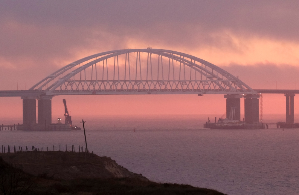 A general view shows a road-and-rail bridge constructed to connect the Russian mainland with the Crimean peninsula, at sunrise in the Kerch Strait, Crimea November 26, 2018. Reuters/Pavel Rebrov