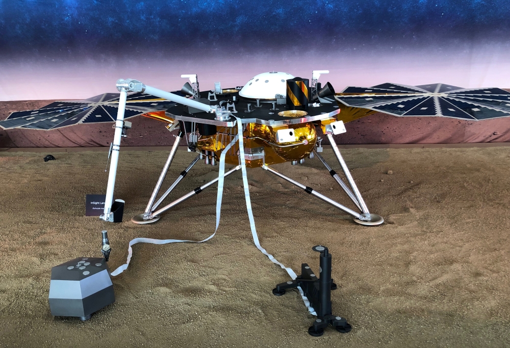 A full-scale replica of NASA's Mars InSight, a robotic stationary lander that marks the first spacecraft designed to study the deep interior of the Red Planet, or any distant world, is seen inside a large tent on the campus of NASA's Jet Propulsion Labora