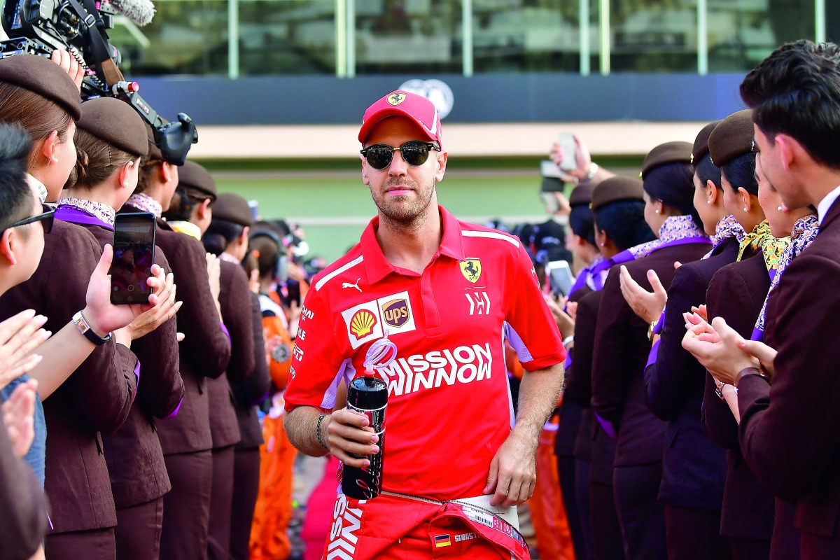 Ferrari's German driver Sebastian Vettel walks ahead of the Abu Dhabi Formula One Grand Prix at the Yas Marina circuit on November 25, 2018, in Abu Dhabi. AFP / Andrej Isakovic