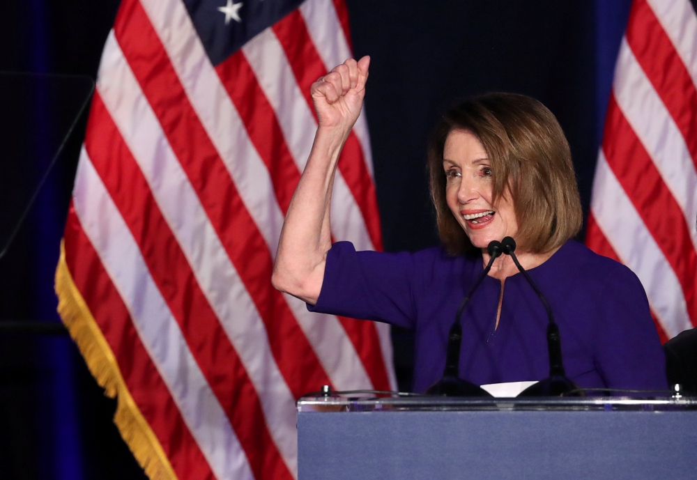 FILE PHOTO: U.S. House Minority Leader Nancy Pelosi celebrates the Democrats winning a majority in the U.S. House of Representatives in the U.S. midterm elections during a Democratic election night party in Washington, U.S. November 6, 2018. REUTERS/Jonat