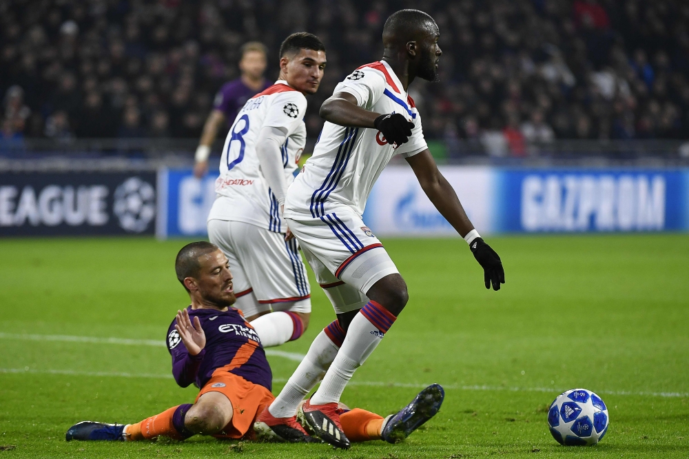 Manchester City's Spanish midfielder David Silva (C) vies with Lyon's French midfielder Tanguy Ndombele (R) and Lyon's forward Houssem Aouar (L) during the UEFA Champions League Group F football match between Olympique Lyonnais and Manchester City at the 