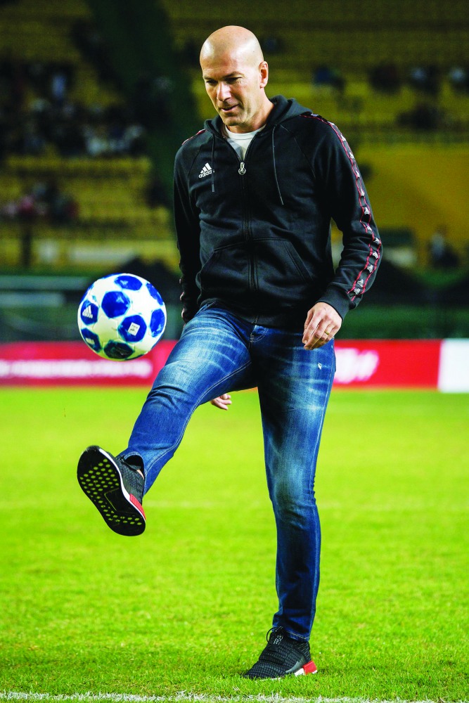 Former French football player Zinedine Zidan controls the ball at a promotional event for the Chinese University of Football Association in Guangzhou, in China's southern Guangdong province on November 30, 2018. AFP
