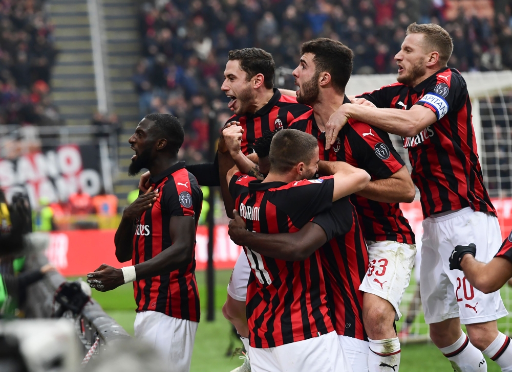 AC Milan's players celebrate after scoring a penalty during the Italian Serie A football match AC Milan vs Parma on Decembre 2, 2018 at the San Siro stadium in Milan. / AFP / Miguel MEDINA