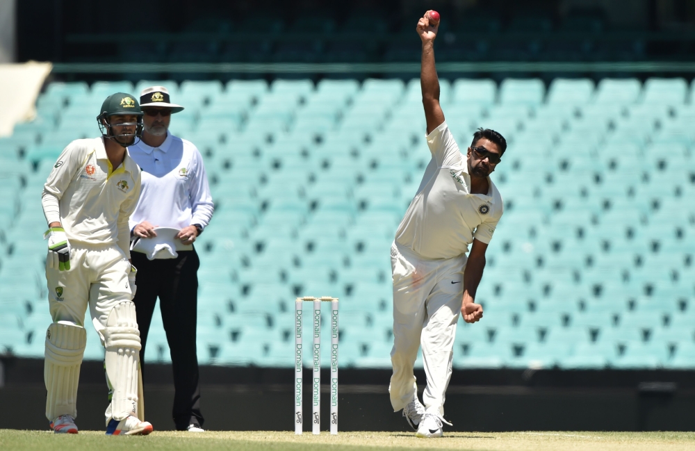 India's spin bowler Ravi Ashwin (R) bowls on the third day of the tour match against Cricket Australia XI at the SCG in Sydney on November 30, 2018. AFP / PETER PARKS