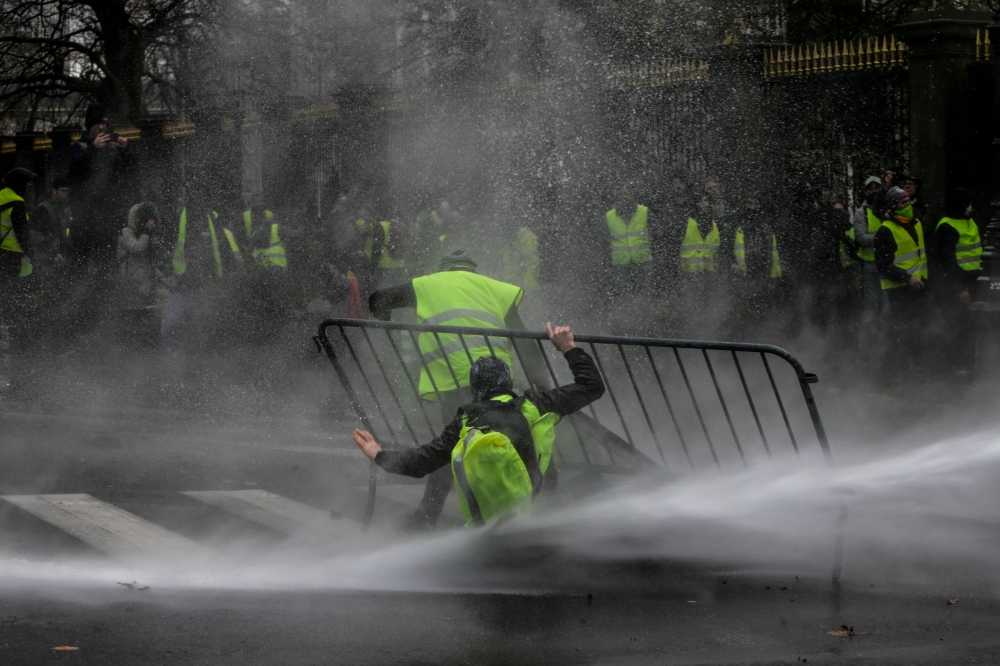 Anti-riot police use a water cannon during clashes with 
