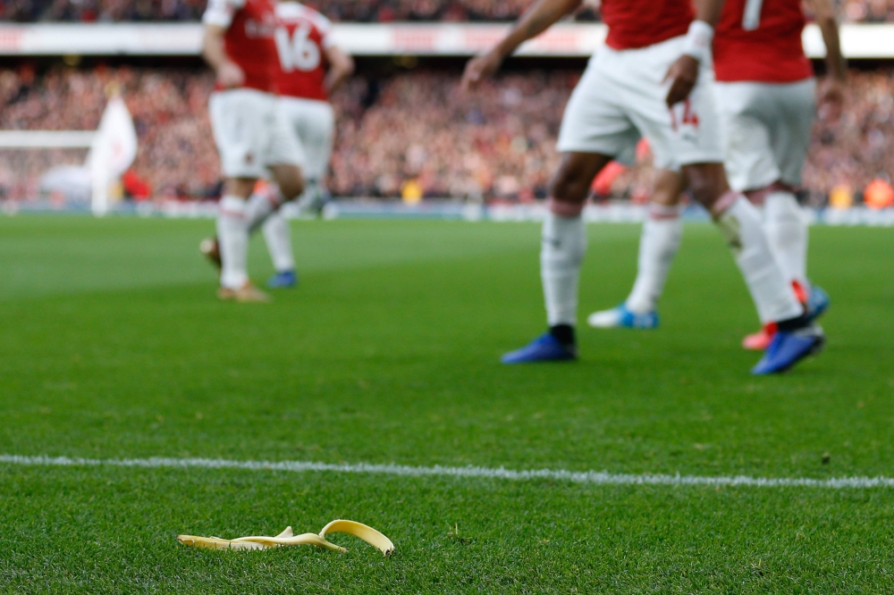 A banana thrown from the crowd is seen at the side of the pitch as Arsenal's Gabonese striker Pierre-Emerick Aubameyang at the Emirates Stadium in London on December 2, 2018. / AFP / IKIMAGES / Ian KINGTON 
