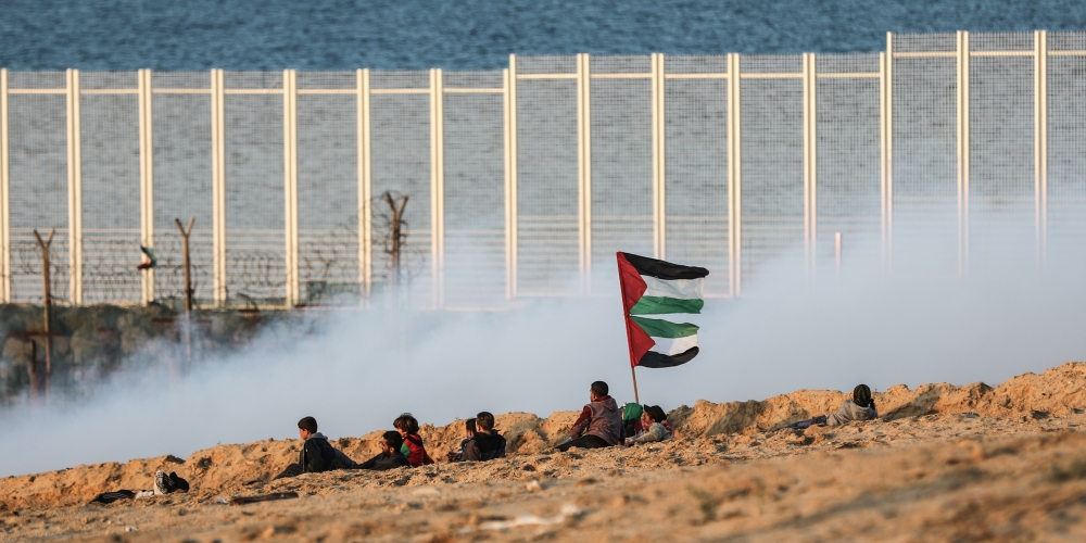 Israeli forces intervene protesters with gas bombs as Palestinians gather to support the 18th 'maritime demonstration' to break the Gaza blockade by sea with vessel near the north coast border in Gaza City, Gaza on December 3, 2018. (Ali Jadallah/Anadolu 