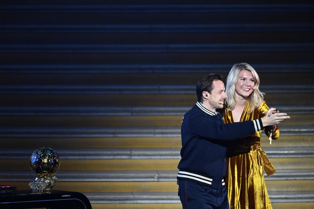 Olympique Lyonnais' Norwegian forward Ada Hegerberg (R) dances with French DJ and producer Martin Solveig after receiving the 2018 FIFA Women's Ballon d'Or award for best player of the year during the 2018 FIFA Ballon d'Or award ceremony at the Grand Pala