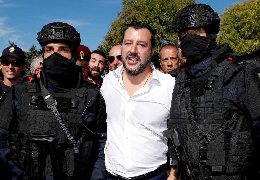 FILE PHOTO: Italian Interior Minister Matteo Salvini poses with two members of the Central Security Operations Service (NOCS), a SWAT team of the Polizia di Stato, during a visit to celebrate their anniversary in Rome, Italy October 10, 2018. REUTERS/Remo