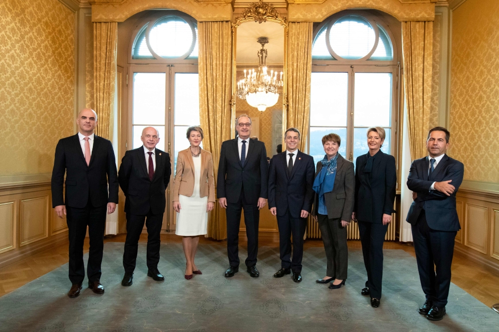 The newly elected Federal Councillors Karin Keller-Sutter (2nd-R), and Viola Amherd (3rd-R) pose with the Federal Council (from left) the Federal President Alain Berset, Federal Councillors Ueli Maurer, Simonetta Sommaruga, Guy Parmelin, Ignazio Cassis an