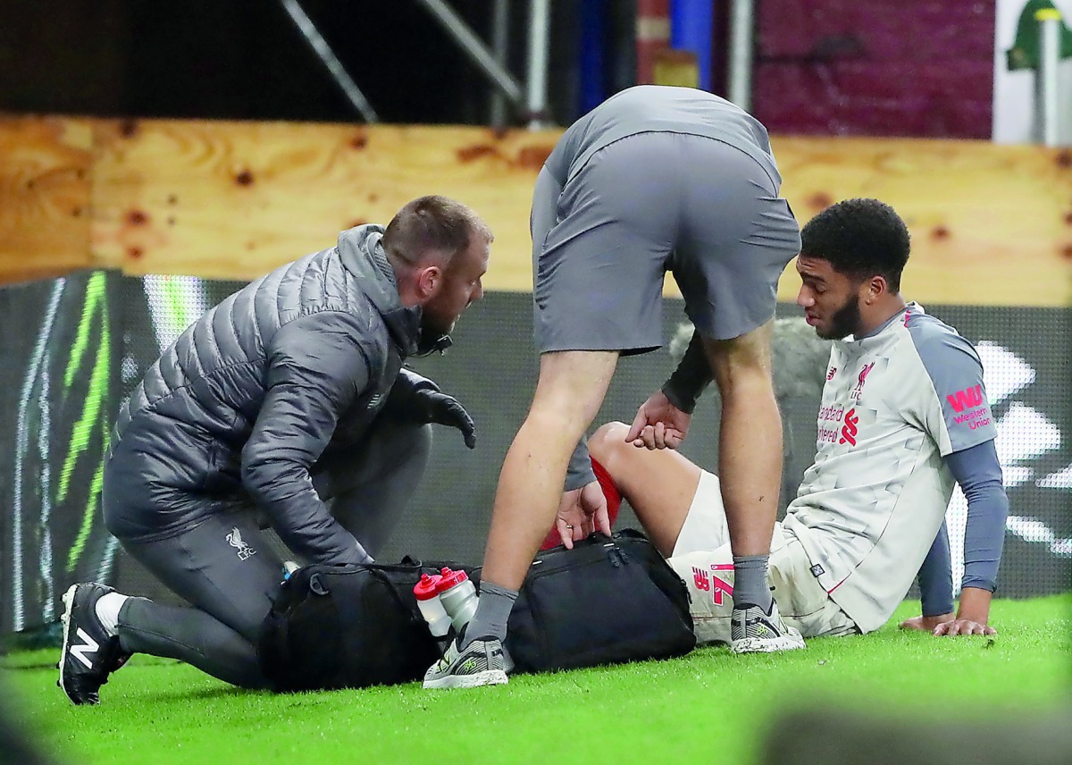 Liverpool's Joe Gomez receives medical attention after sustaining an injury. Reuters/Scott Heppell 