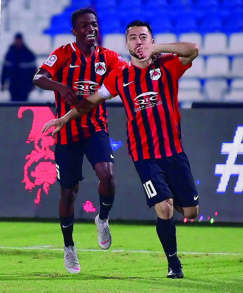 Al Rayyan skipper Rodrigo Tabata (right) celebrates after scoring their fourth goal against Al Kharaitiyat yesterday. 