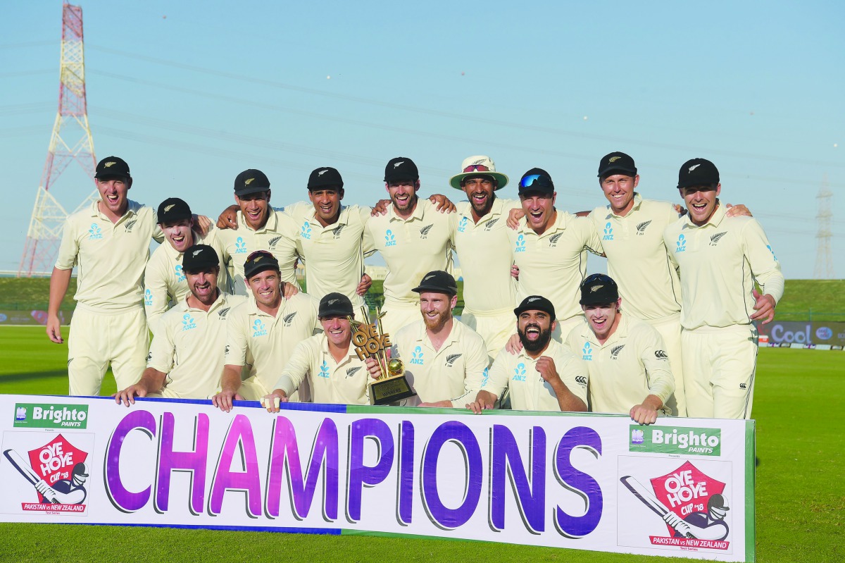 New Zealand cricketers pose with the winner's trophy following the third and final Test cricket match between Pakistan and New Zealand at the Sheikh Zayed International Cricket Stadium in Abu Dhabi on December 7, 2018.  AFP / Aamir Qureshi 
