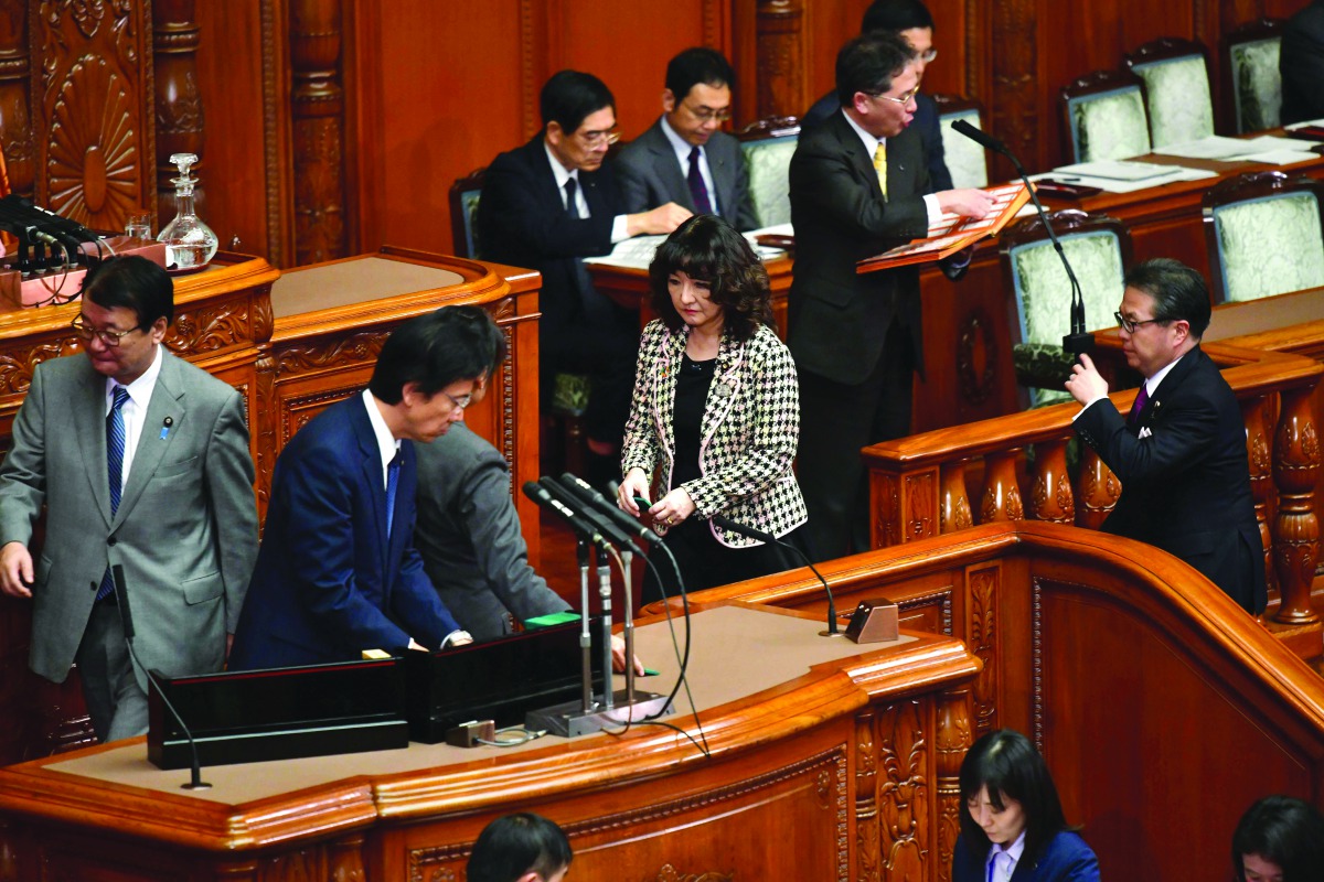 Parliament members of the ruling party vote during a plenary session of the upper house at parliament in Tokyo on December 7, 2018.  AFP / Kazuhiro Nogi

