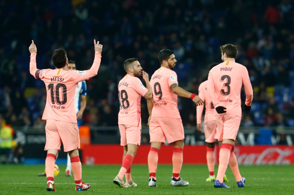 Barcelona's Argentinian forward Lionel Messi (L) celebrates after scoring during the Spanish league football match RCD Espanyol against FC Barcelona at the RCDE Stadium in Cornella de Llobregat on December 8, 2018. / AFP / PAU BARRENA