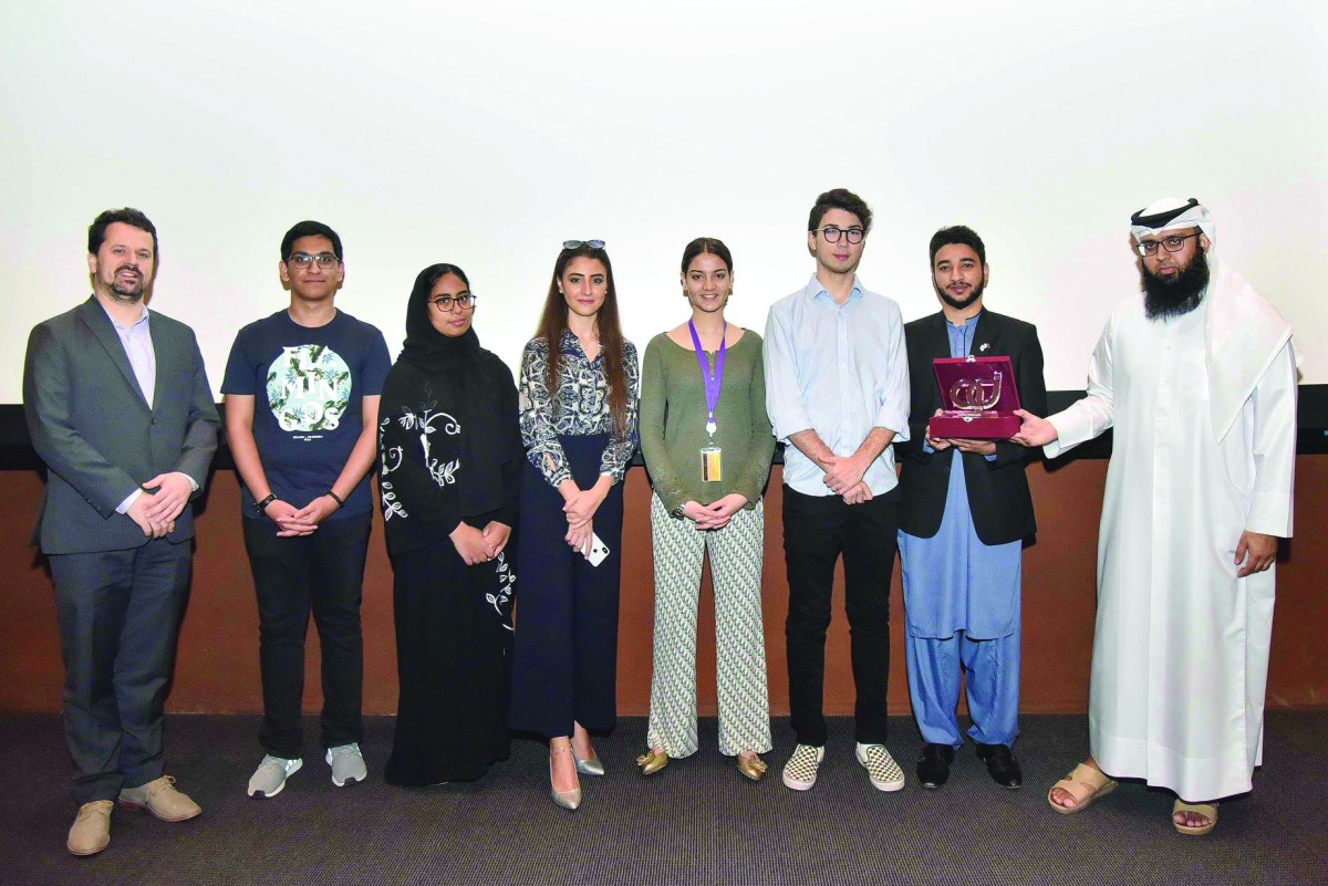 NU-Q Debate Club receives the award from QatarDebate.  