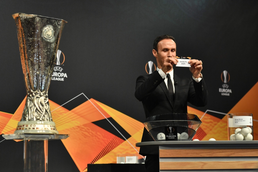 Former Portuguese football player Ricardo Carvalho shows the slip of Sevilla FC next to the cup during the draw for the round of 32 of the UEFA Europa League football tournament at the UEFA headquarters in Nyon on December 17, 2018. / AFP / Fabrice COFFRI