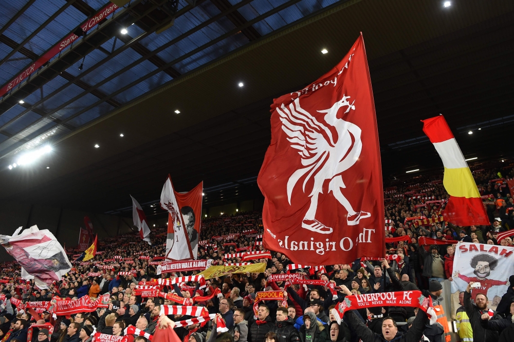 Liverpool fans hold up flags and banners in the crowd ahead of the English Premier League football match between Liverpool and Manchester United at Anfield in Liverpool, north west England on December 16, 2018. AFP / Paul ELLIS