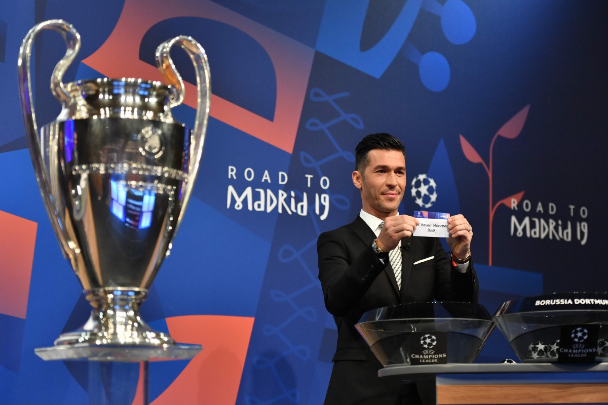 Former Spanish player Luis Garcia shows the slip of Bayern Munchen next to the Cup during the draw for the UEFA Champions League last-16 in Nyon, yesterday. 