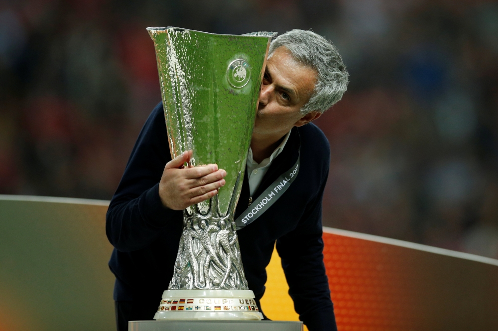 :FILE PHOTO: Manchester United manager Jose Mourinho celebrates winning the Europa League with the trophy Reuters / Andrew Couldridge/File Photo