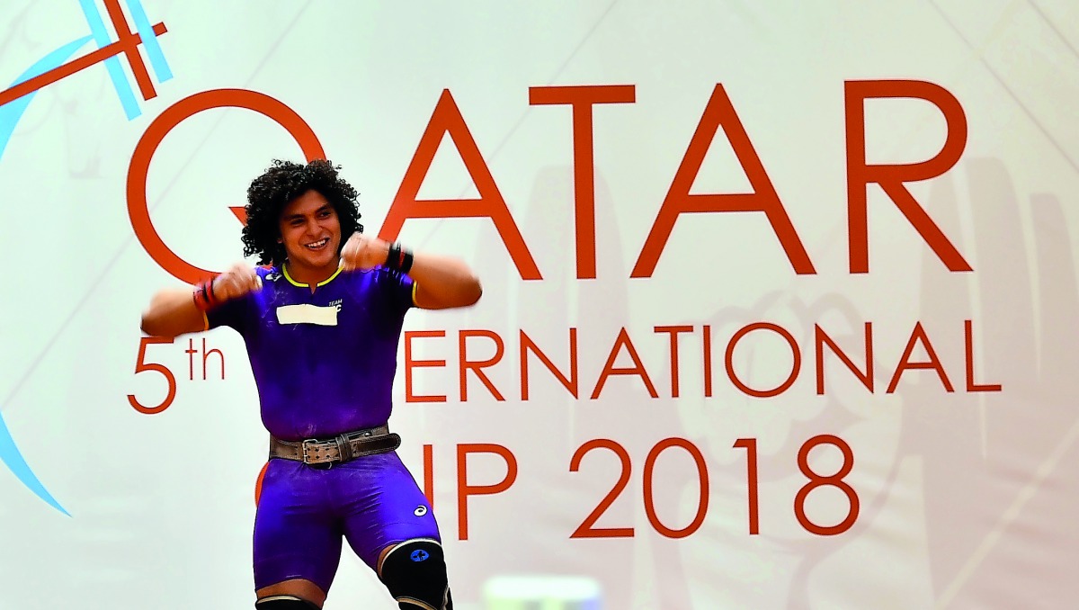 Qatari weightlifting star Fares Ibrahim Hassouna celebrates after winning the gold medal in the men’s 96kg category (Group A), during the 5th edition of Qatar International Cup 2018 at the InterContinental Doha yesterday. Picture: Syed Omar 

