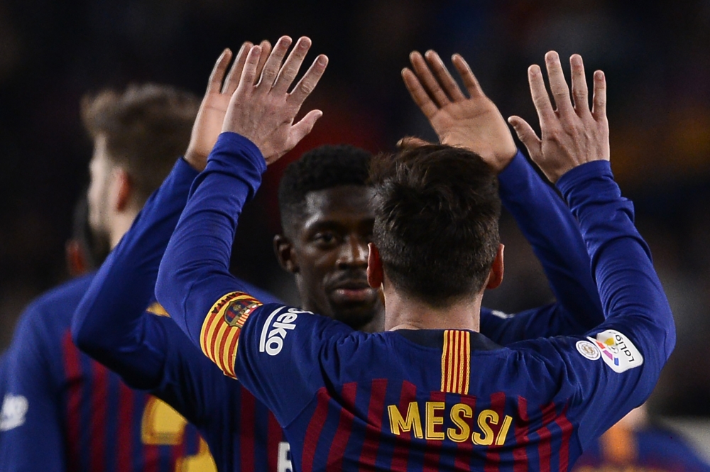  Barcelona's Argentinian forward Lionel Messi celebrates with Barcelona's French forward Ousmane Dembele scoring a goal during the Spanish League football match between FC Barcelona and RC Celta de Vigo at the Camp Nou stadium in Barcelona on Decemeber 22