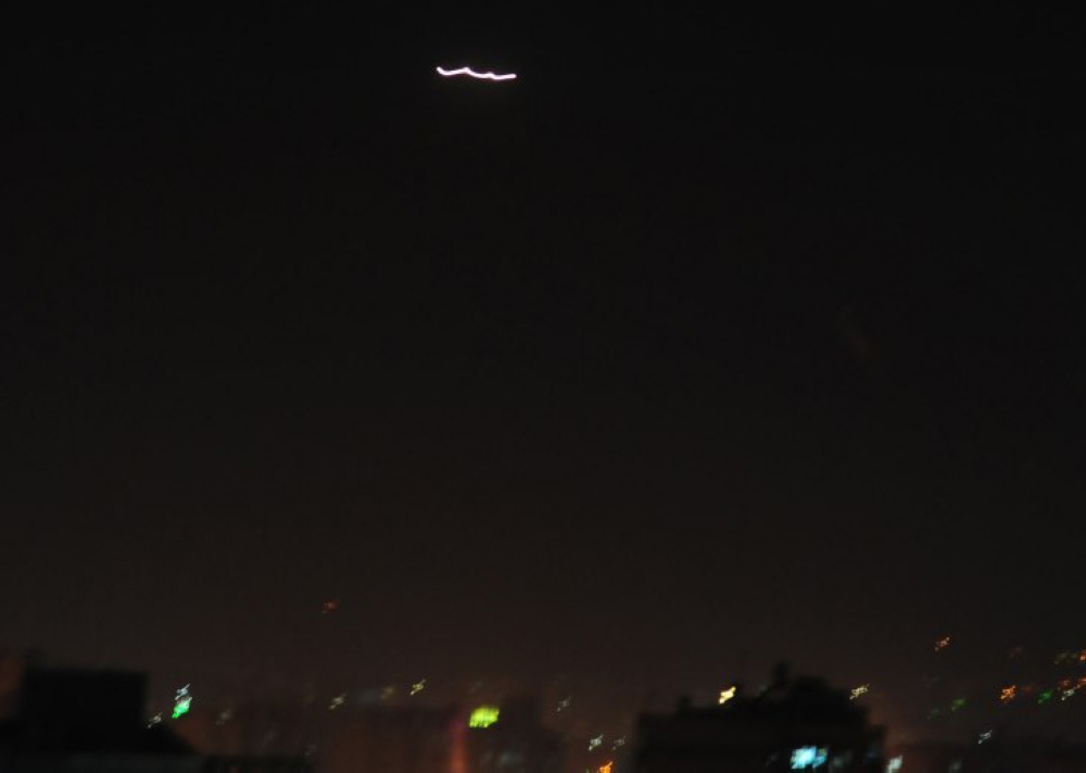 A streak of light in the sky of the Syrian capital Damascus. Syrian air defences opened fire on 