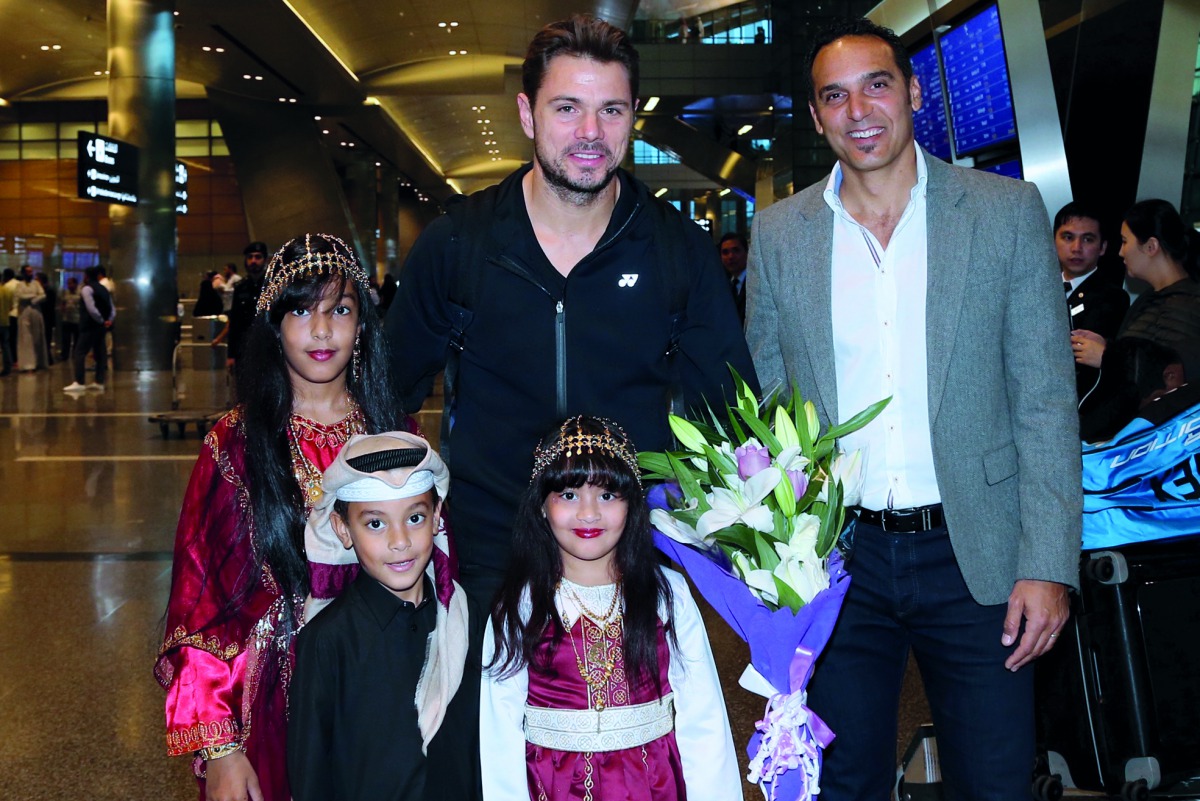 Alami poses for a photograph with Switzerland’s Stan Wawrinka (centre) who also arrived in Doha yesterday. 
