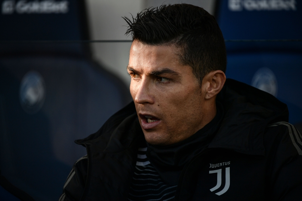 Juventus' Portuguese forward Cristiano Ronaldo looks on from the substitutes' bench prior to the Italian Serie A football Match Atalanta Bergamo vs Juventus on December 26, 2018 at the Atleti Azzurri d'Italia stadium in Bergamo. / AFP / Marco BERTORELLO