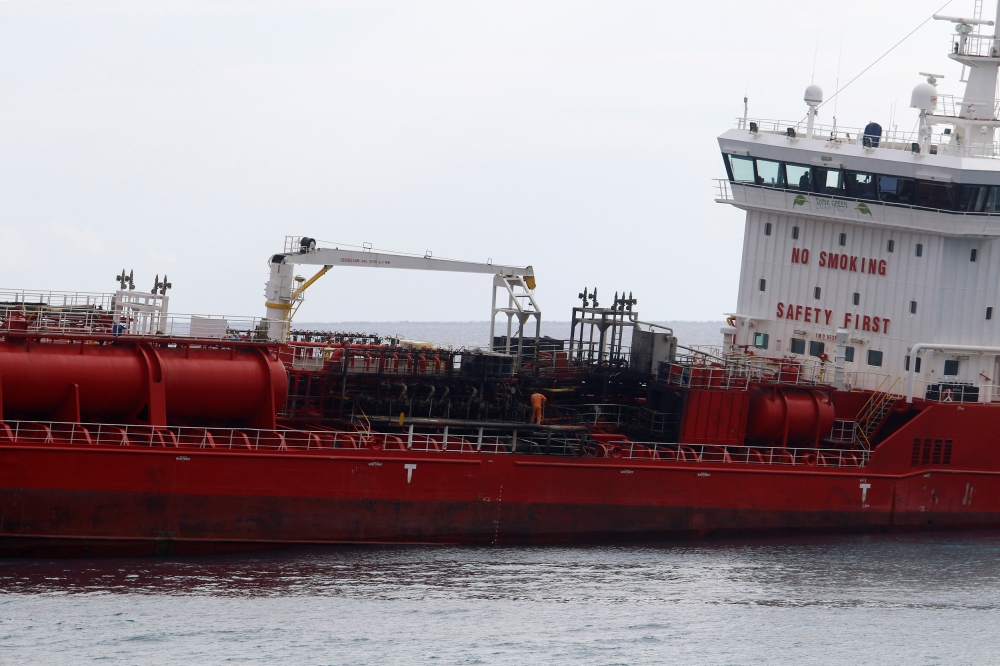 A man is seen on the M/V Athlos tanker, which is anchored following a fire that broke out on board injuring two members of the crew, according to local media, off the shores of Zygi, Cyprus December 29, 2018. REUTERS/Yiannis Kourtoglou