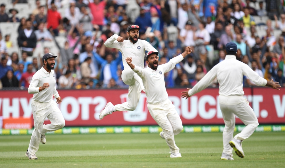 India's captain Virat Kohli, Cheteshwar Pujara and Ajinkya Rahane celebrate after winning the third test match between Australia and India at the MCG in Melbourne, Australia, December 30, 2018. (AAP/Julian Smith/via REUTERS)
