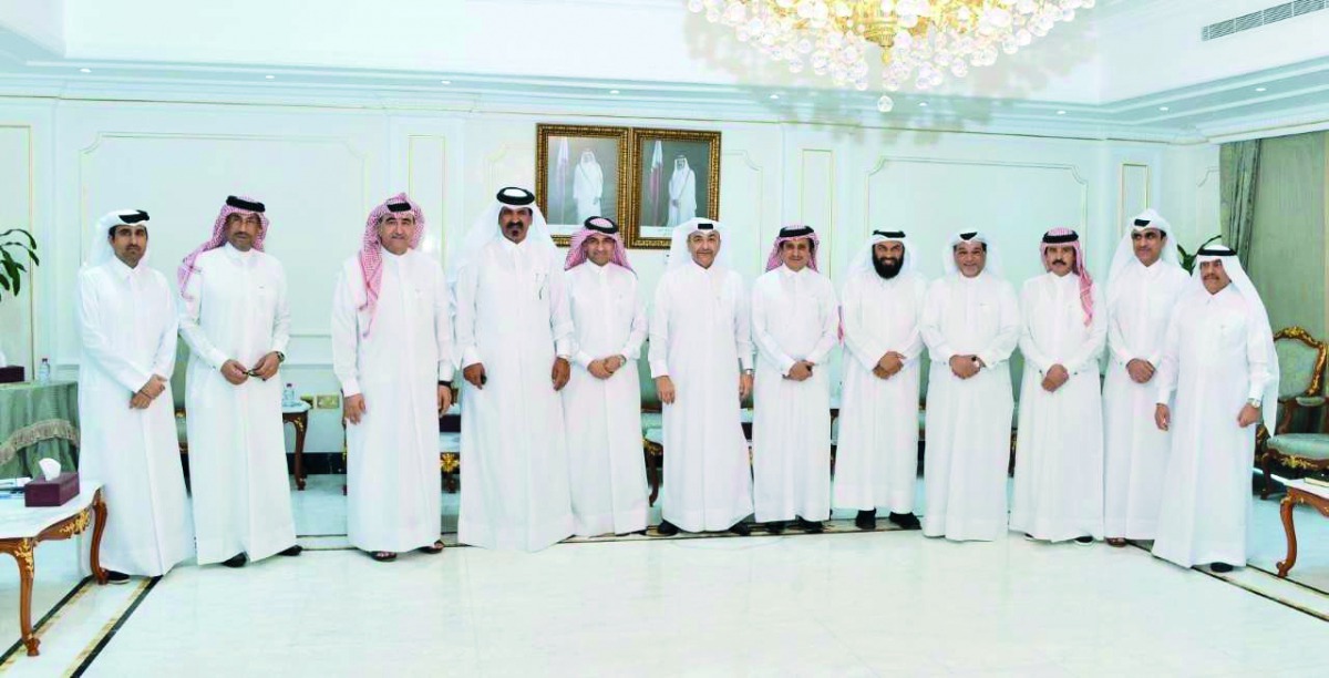 Officials of Qatar Chamber and the Ministry of Administrative Development, Labour and Social Affairs (MADLSA) pose for a group picture.