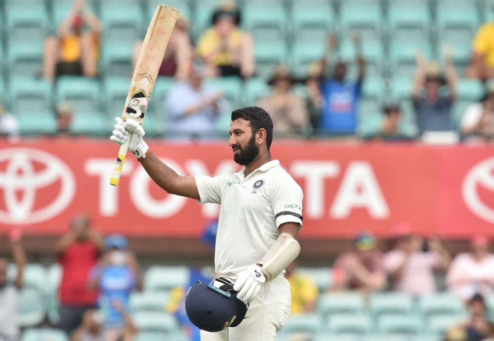 India batsman Cheteshwar Pujara celebrates his century against Australia during the first day of the fourth and final cricket Test at the Sydney Cricket Ground in Sydney on January 3, 2019. AFP / PETER PARKS