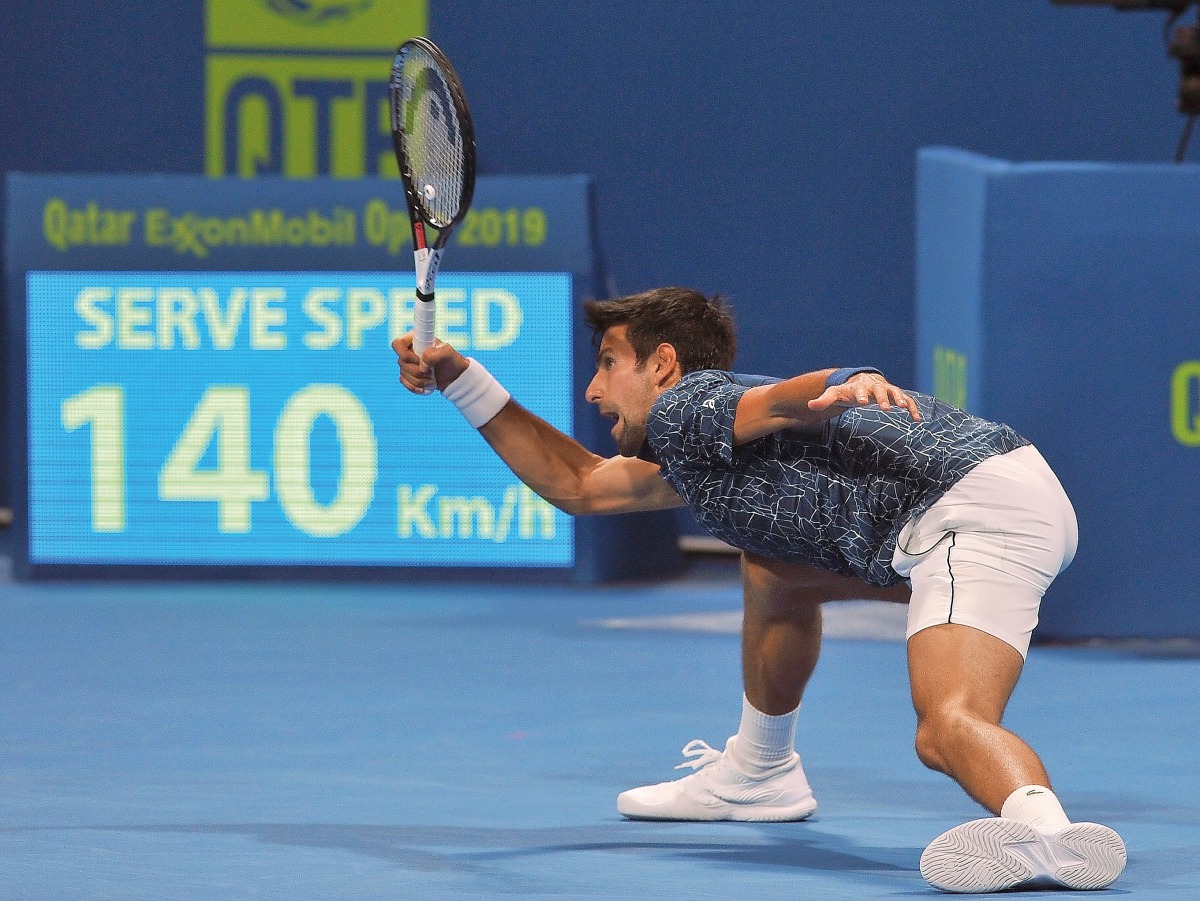 Novak Djokovic of Serbia returns the ball to Marton Fucsovics of Hungary during their Qatar ExxonMobil Open match played at the Khalifa Tennis and Squash Complex in Doha yesterday. (Picture: Salim Matramkot/The Peninsula)