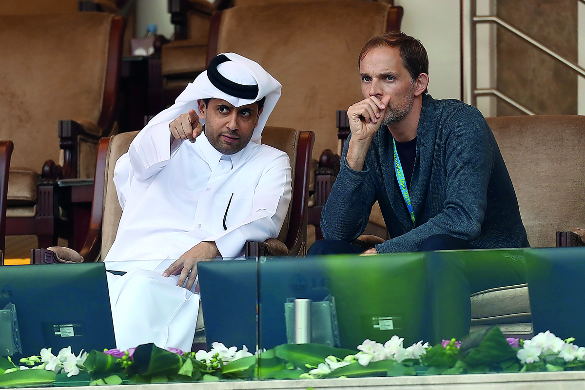 Paris Saint-Germain FC’s (PSG) and Qatar Tennis Federation (QTF) President Nasser bin Ghanim Al Khelaifi (left) gestures as he speaks to PSG’s manager Thomas Tuchel, while watching the ATP Qatar ExxonMobil Open tennis match between Stan Wawrinka of Switze
