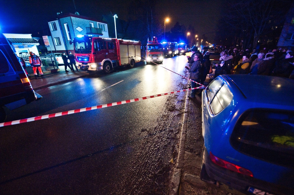 Police and firefighters stand in front of a place, where a fire that broke out in an escape room killed five teenage girls, in the northern Polish city of Koszalin on January 4, 2019. Poland OUT / AFP / REPORTER / Radoslaw Kolesnik