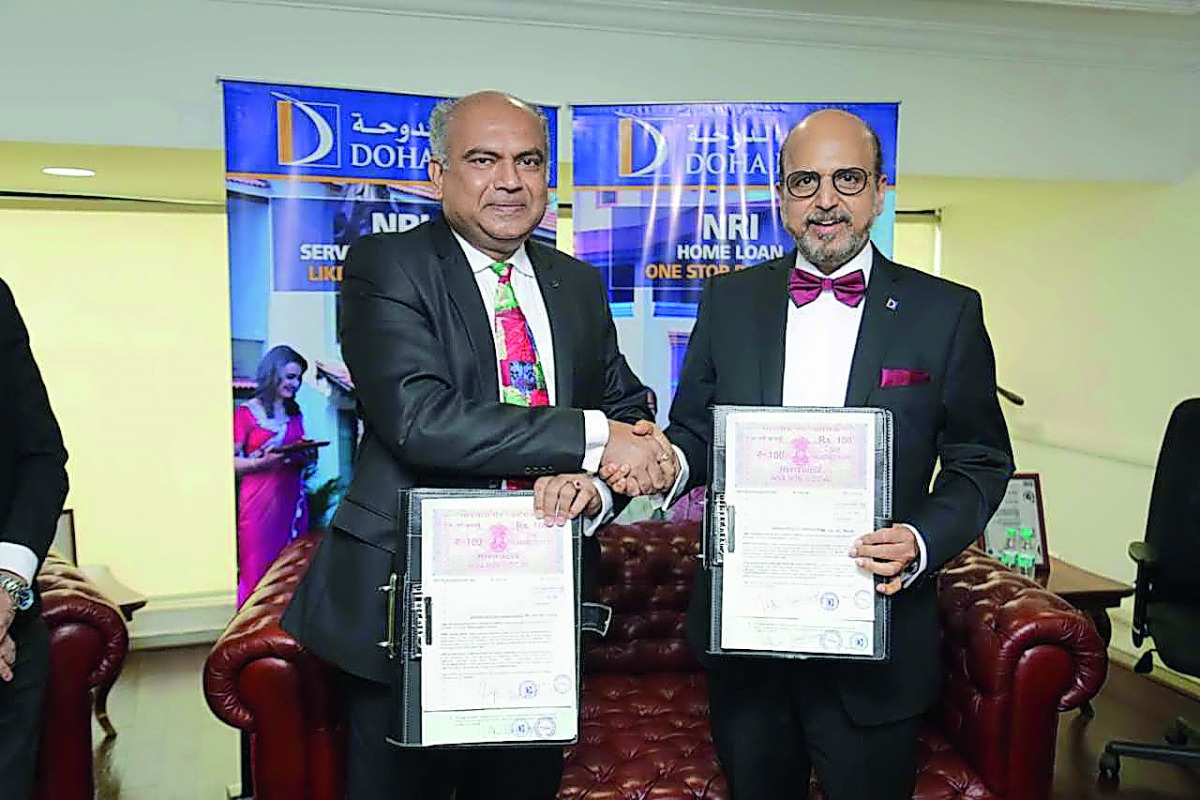 Dr. R Seetharaman (right), CEO of Doha Bank, and a StockHolding official during the signing ceremony.