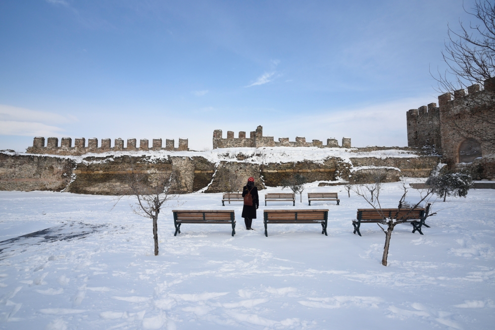 A woman visits the Byzantine-era Heptapyrgion castle following snowfall in Thessaloniki, Greece, January 5, 2019. REUTERS/Alexandros Avramidis
