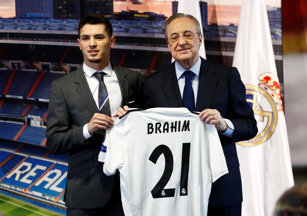 Brahim Diaz poses with his shirt alongside Real Madrid president Florentino Perez during the presentation REUTERS/Juan Medina