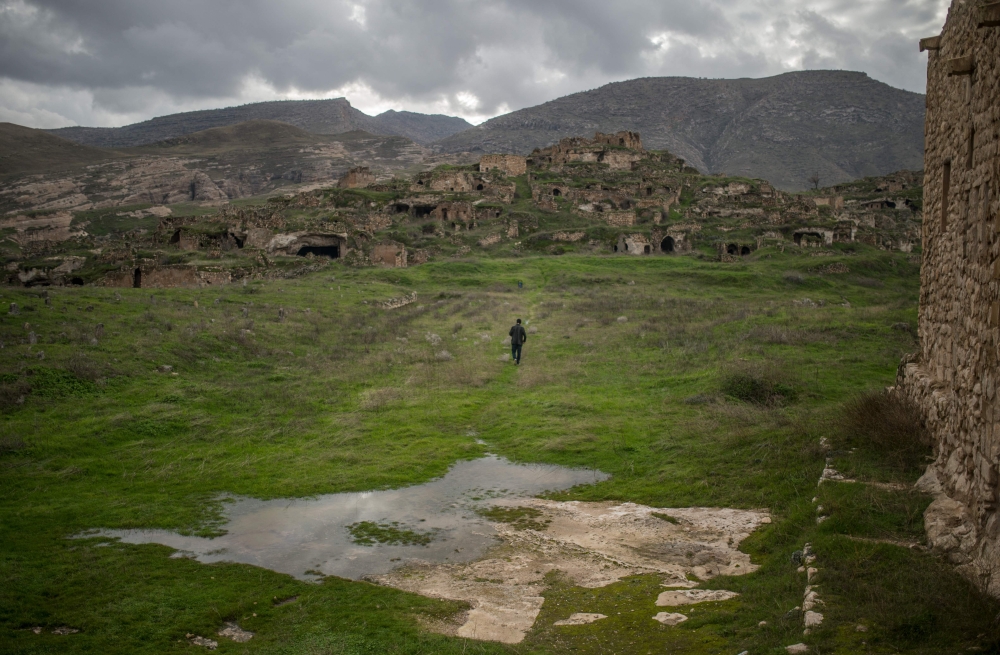 Ridvan Ayhan, a 58-year-old activist who fights against the Ilisi hydroelectric dam project, walks at a historical site in Hasankeyf, in Turkey's Kurdish-majority southeast, on December 13, 2018. AFP / BULENT KILIC
