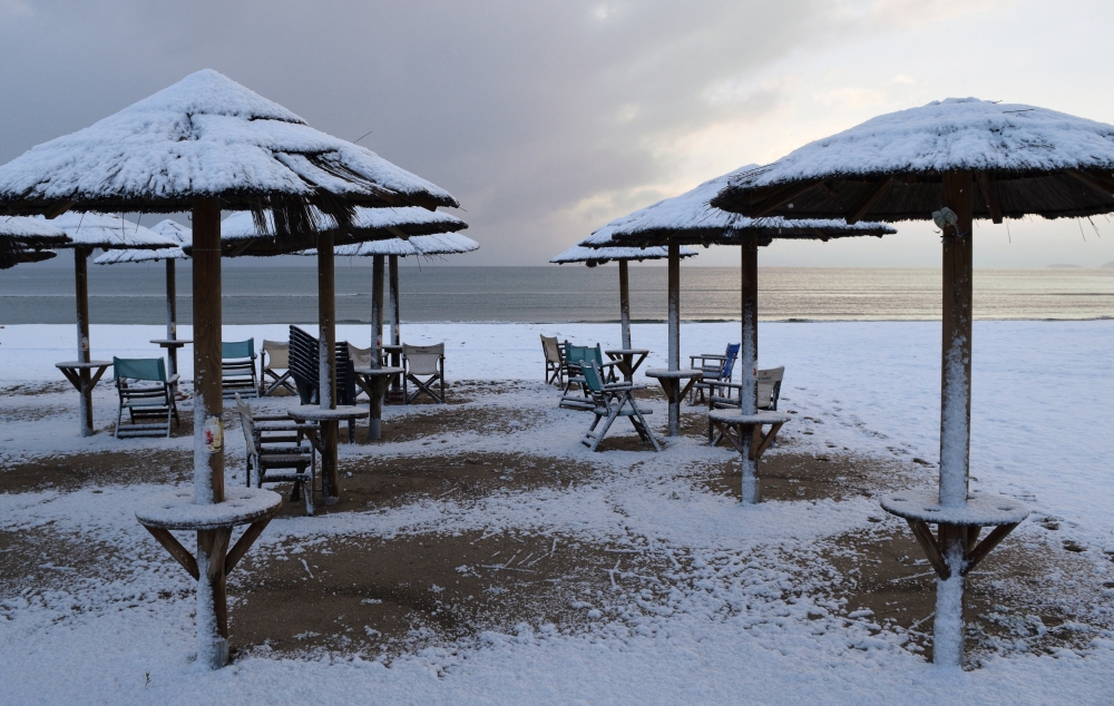 Beach umbrellas are covered with snow at the beach in the town of Artemida, Greece January 8, 2019. REUTERS/Vassilis Triandafyllou