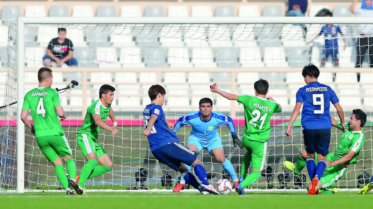 Japan’s Yuya Osako scores their first goal during their AFC Asian Cup match against Turkmenistan in the Group F match at  the Al Nahyan Stadium in Abu Dhabi, yesterday.