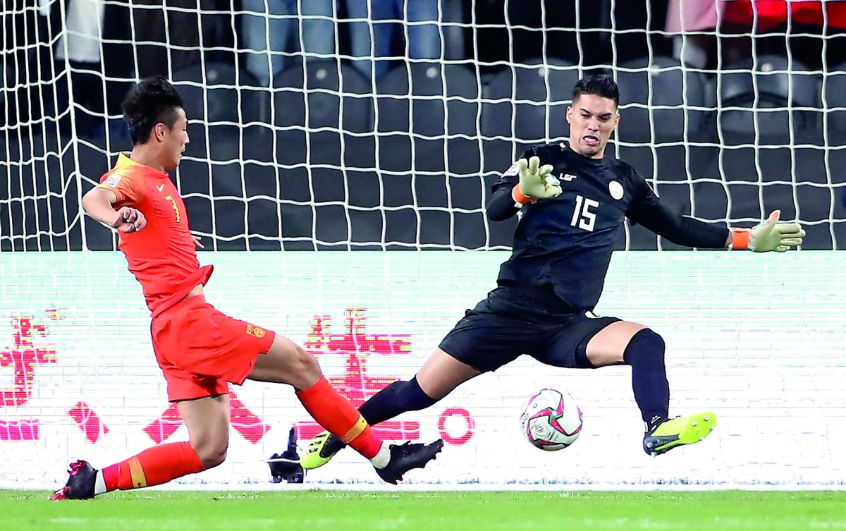 Philippines’ Michael Falkesgaard makes a save from China’s Wu Lei during their AFC Asian Cup Group C at Mohammed bin Zayed Stadium in Abu Dhabi, yesterday.  Reuters/Suhaib Salem 