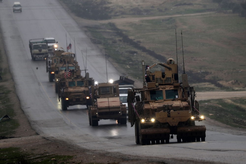 (FILES) In this file photo taken on December 30, 2018 a convoy of US military vehicles rides in Syria's northern city of Manbij. AFP / Delil SOULEIMAN