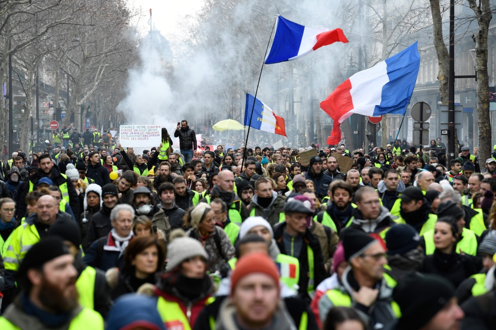 People march in the streets of center Paris, on January 12, 2019 during an anti-government demonstration called by the Yellow Vest 