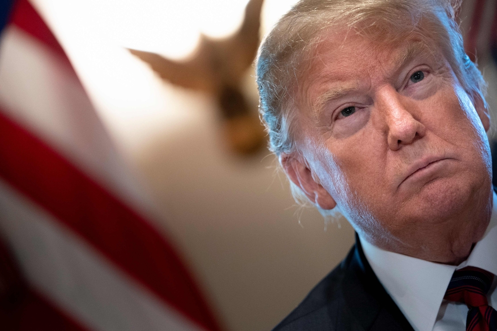 US President Donald Trump listens during a meeting on border security in the Cabinet Room of the White House January 11, 2019 in Washington, DC. / AFP / Brendan Smialowski 