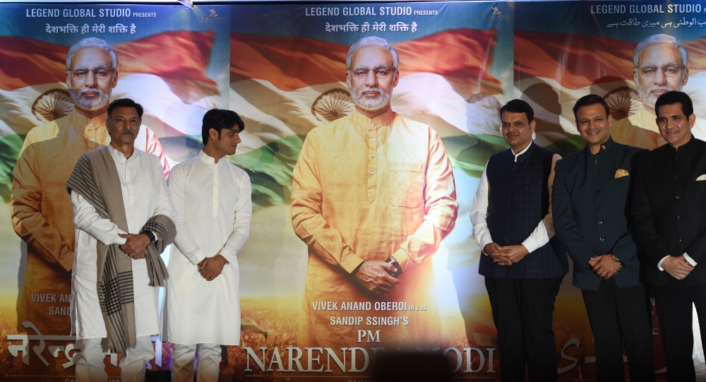 Indian actor Suresh Oberoi (L), producer Sandip S Singh (2L), Maharashtra Chief Minister Devendra Fadnavis (C), actor Vivek Oberoi (2R) and director Umang Kumar pose with posters of the upcoming Bollywood film 