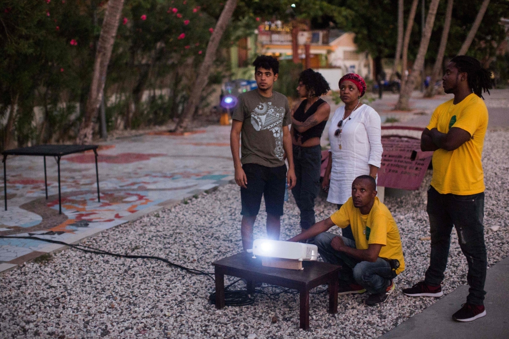 People set up for a film projection next to the beach as part of the Festival 