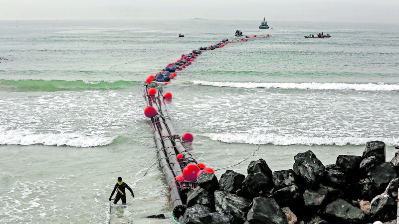 Seawater intake pipes are pulled ashore to attach them to the Strandfontein desalination plant in Cape Town(Mike Hutchings, Reuters)